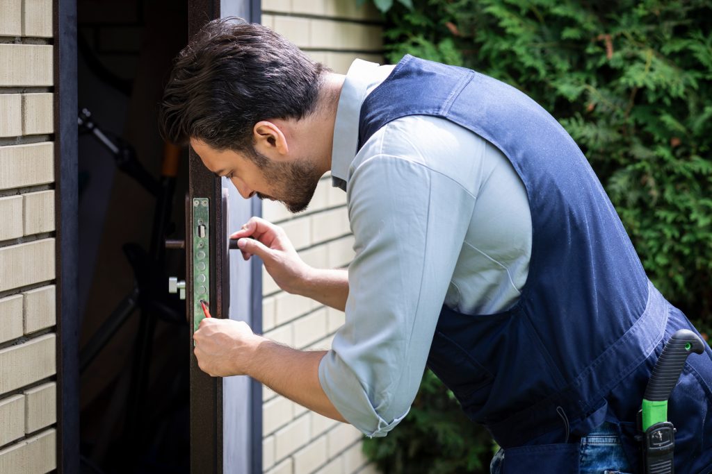 Close-up shot of a concentrated craftsman fixing a door